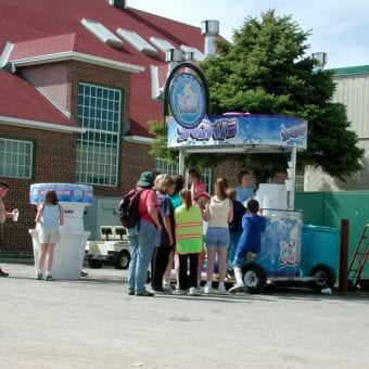 People in line at a Snowie Cart