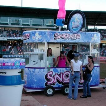 Snowie Kiosk at a Baseball Game with People in the stands behind